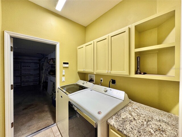 2519 Cypress Trace Cir, Orlando, FL 32825 - washroom with washer and clothes dryer, light tile patterned flooring, cabinet space, and light colored carpet