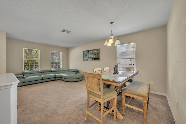 5910 Windsong Oak Dr, Leesburg, FL 34748 - carpeted dining room with visible vents, baseboards, a textured ceiling, and an inviting chandelier