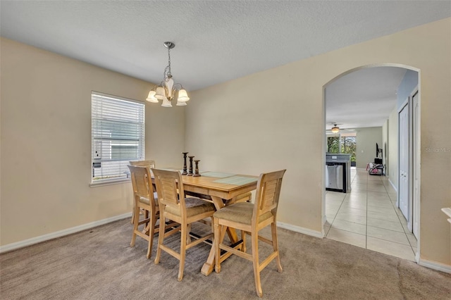 5910 Windsong Oak Dr, Leesburg, FL 34748 - dining area featuring light tile patterned floors, arched walkways, a wealth of natural light, and light carpet