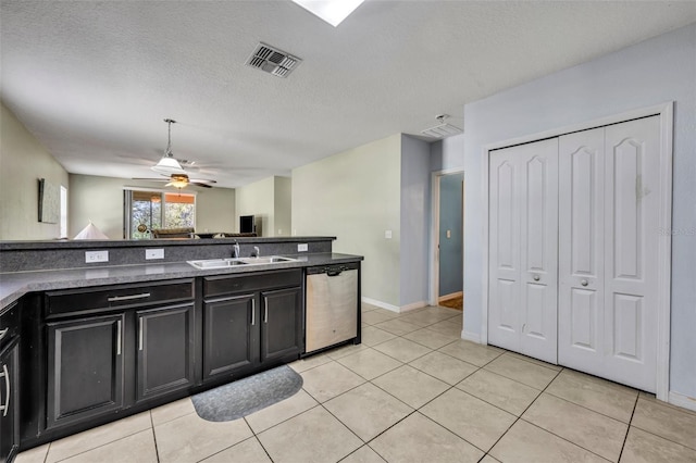 5910 Windsong Oak Dr, Leesburg, FL 34748 - kitchen featuring dark cabinetry, visible vents, ceiling fan, a sink, and stainless steel dishwasher