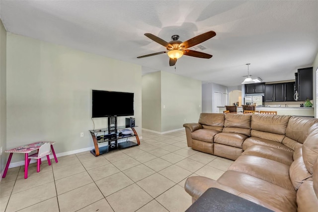 5910 Windsong Oak Dr, Leesburg, FL 34748 - living area with light tile patterned floors, a ceiling fan, visible vents, baseboards, and a textured ceiling