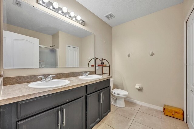 5910 Windsong Oak Dr, Leesburg, FL 34748 - bathroom featuring a sink, visible vents, double vanity, and tile patterned floors