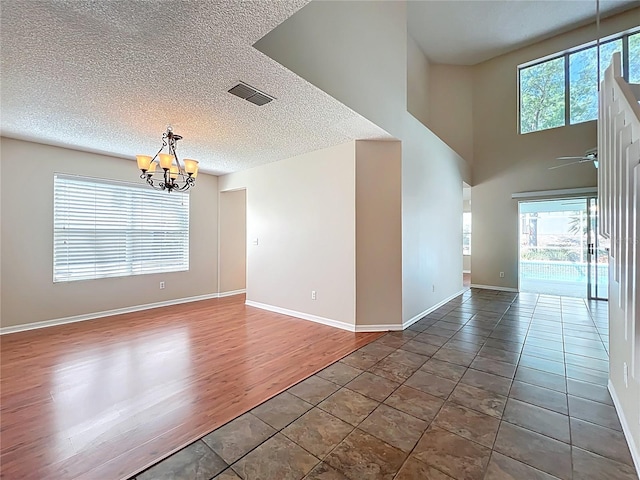 358 Morning Creek Cir, Apopka, FL 32712 - unfurnished room featuring visible vents, ceiling fan with notable chandelier, a textured ceiling, and baseboards