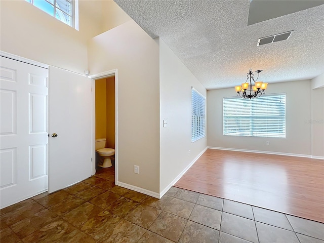 358 Morning Creek Cir, Apopka, FL 32712 - interior space featuring an inviting chandelier, baseboards, visible vents, and a textured ceiling