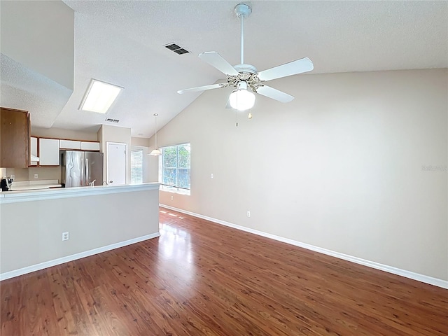 358 Morning Creek Cir, Apopka, FL 32712 - unfurnished living room with visible vents, baseboards, lofted ceiling, wood finished floors, and a ceiling fan