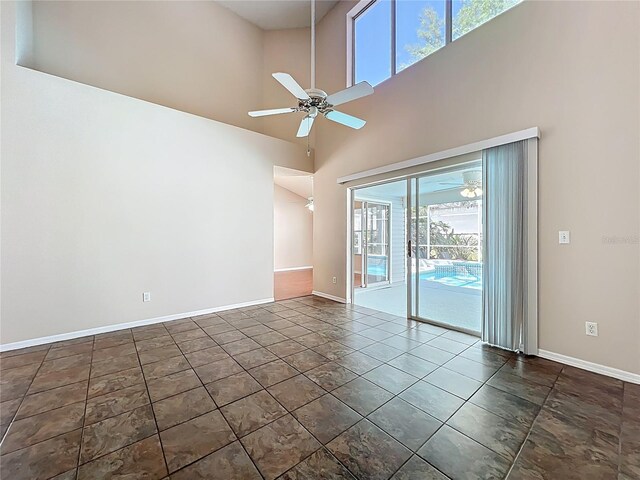 358 Morning Creek Cir, Apopka, FL 32712 - tiled empty room with baseboards, a high ceiling, and ceiling fan