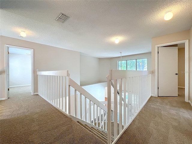 358 Morning Creek Cir, Apopka, FL 32712 - hallway featuring visible vents, carpet floors, a textured ceiling, and an upstairs landing