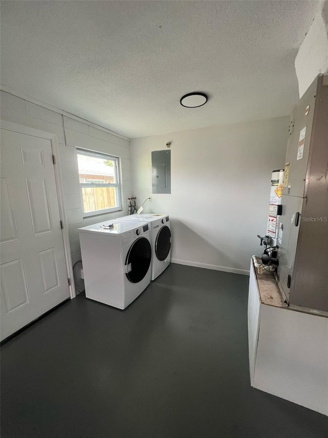 6130 Gamble Dr, Orlando, FL 32808 - laundry room with electric panel, separate washer and dryer, laundry area, and a textured ceiling