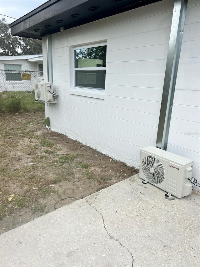6130 Gamble Dr, Orlando, FL 32808 - view of side of home with concrete block siding, ac unit, and fence