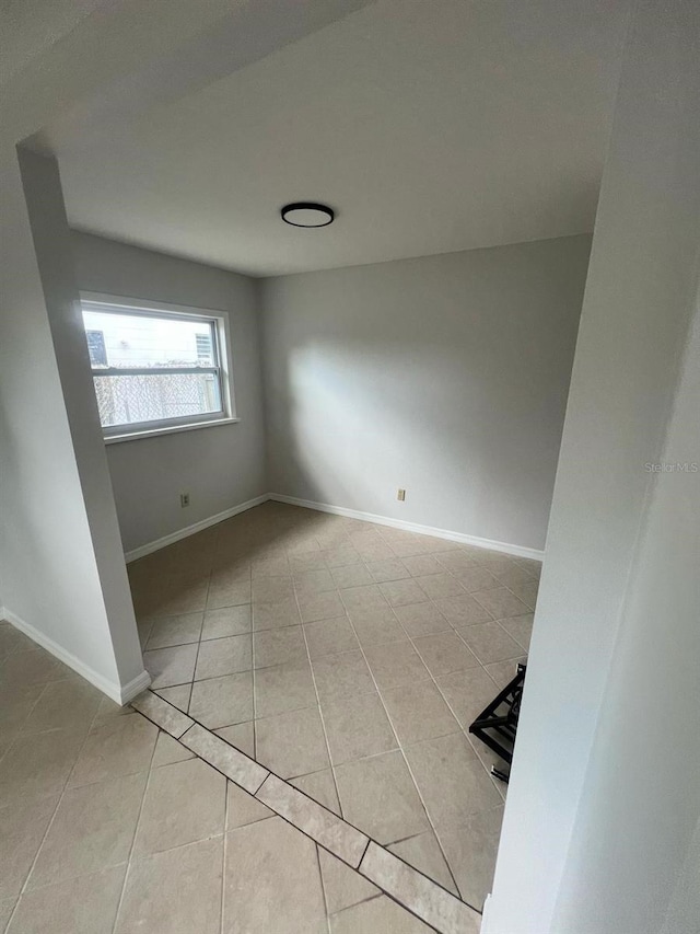 6130 Gamble Dr, Orlando, FL 32808 - empty room with light tile patterned floors and baseboards