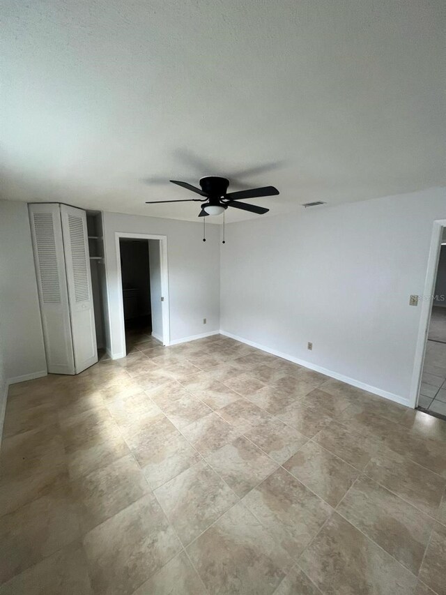 6130 Gamble Dr, Orlando, FL 32808 - unfurnished bedroom featuring ceiling fan, baseboards, and multiple closets
