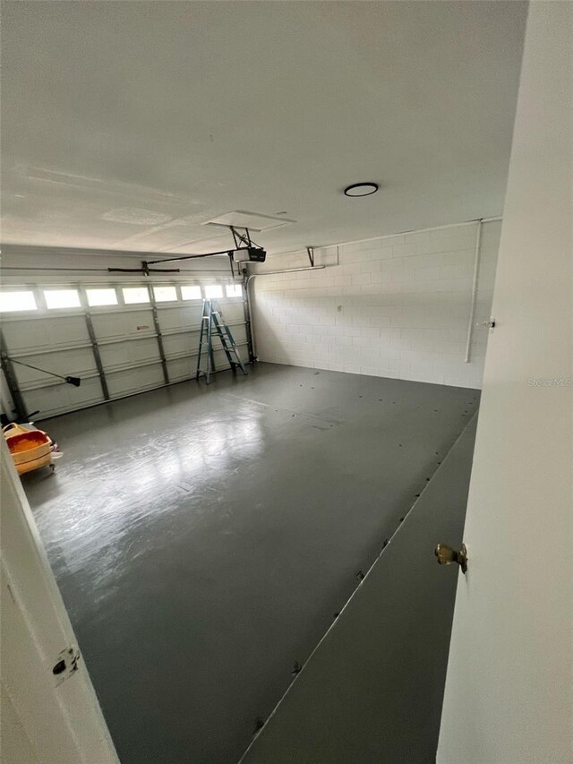 6130 Gamble Dr, Orlando, FL 32808 - garage with a garage door opener and concrete block wall