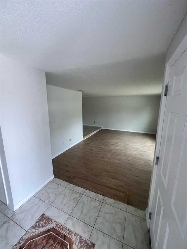 6130 Gamble Dr, Orlando, FL 32808 - unfurnished room featuring baseboards, light wood-style floors, and a textured ceiling