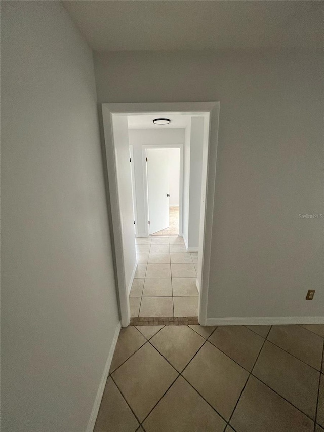 6130 Gamble Dr, Orlando, FL 32808 - corridor featuring light tile patterned flooring and baseboards