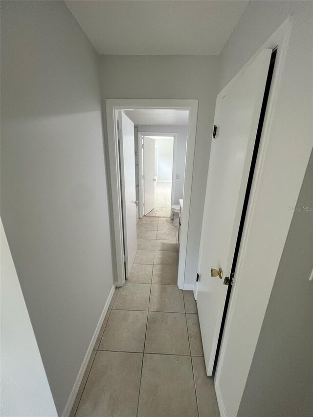 6130 Gamble Dr, Orlando, FL 32808 - hall with light tile patterned floors and baseboards