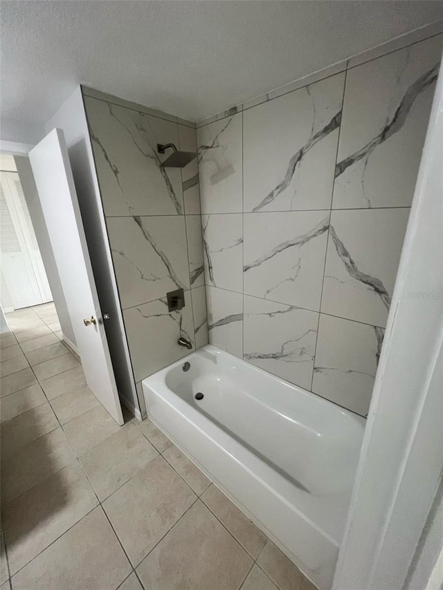 6130 Gamble Dr, Orlando, FL 32808 - bathroom with tile patterned floors, a textured ceiling, and washtub / shower combination