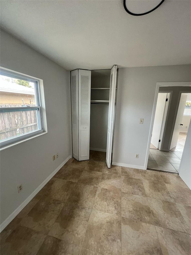6130 Gamble Dr, Orlando, FL 32808 - unfurnished bedroom with baseboards and a closet