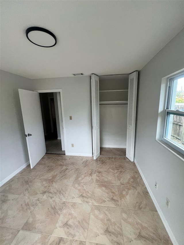 6130 Gamble Dr, Orlando, FL 32808 - unfurnished bedroom with a closet, visible vents, and baseboards