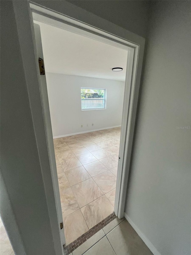 6130 Gamble Dr, Orlando, FL 32808 - corridor with light tile patterned floors and baseboards