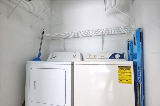 washroom with independent washer and dryer and laundry area