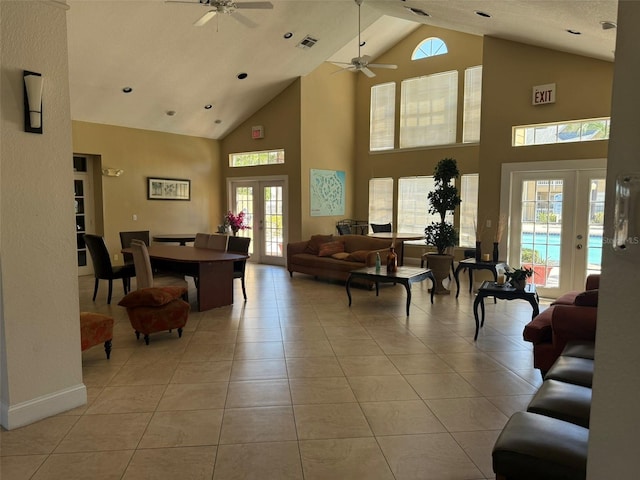living room featuring visible vents, light tile patterned flooring, french doors, and high vaulted ceiling