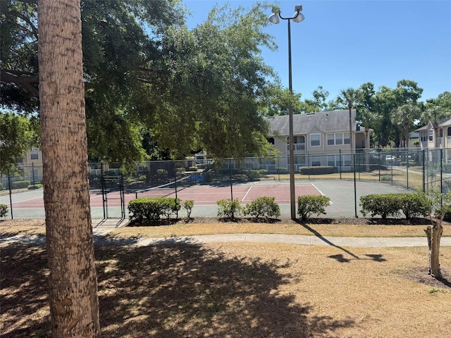 view of tennis court with fence