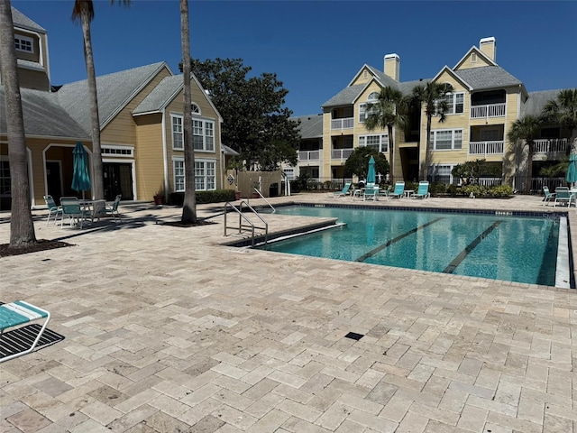 pool with fence and a patio area