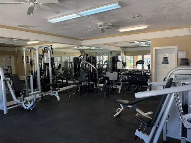 workout area featuring visible vents, a ceiling fan, and a textured ceiling