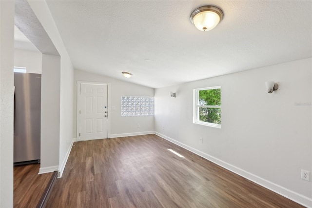 empty room with baseboards and dark wood finished floors