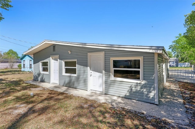 rear view of property featuring fence