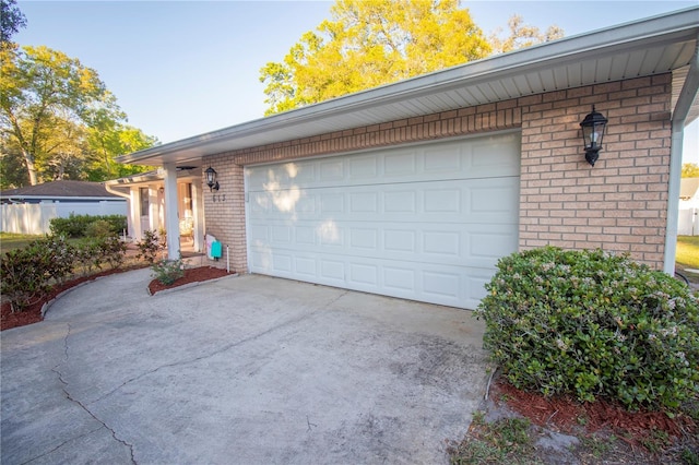 garage featuring concrete driveway