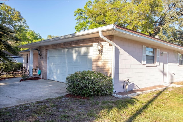 613 Andrew St, Altamonte Springs, FL 32714 - view of side of property featuring concrete driveway and brick siding
