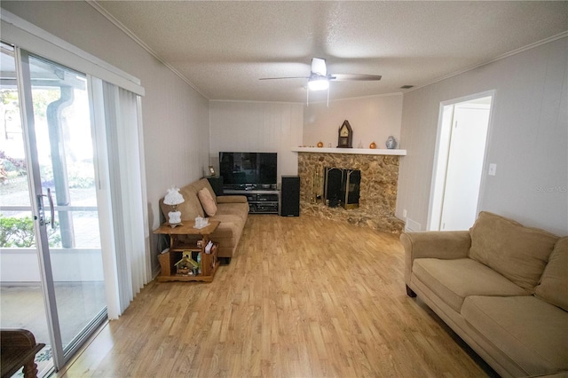 613 Andrew St, Altamonte Springs, FL 32714 - living room with crown molding, light wood-style flooring, a ceiling fan, healthy amount of natural light, and a textured ceiling