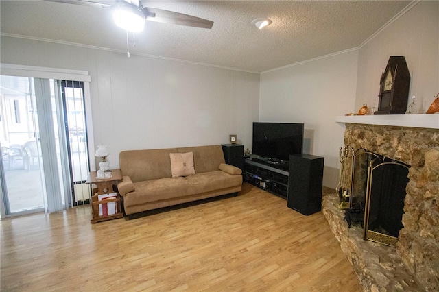 613 Andrew St, Altamonte Springs, FL 32714 - living room with wood finished floors, a textured ceiling, ceiling fan, ornamental molding, and a fireplace