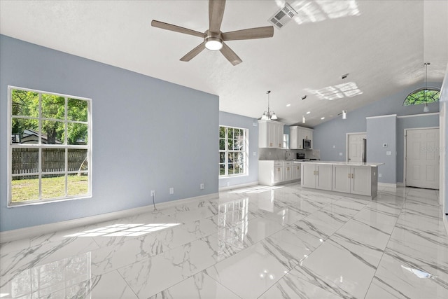 unfurnished living room featuring vaulted ceiling, a ceiling fan, marble finish floor, and visible vents