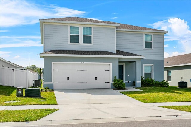 1506 Finnigan Cir, Haines City, FL 33844 - view of front of home with a front lawn, fence, central air condition unit, concrete driveway, and a garage