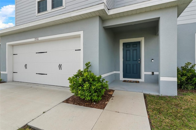 1506 Finnigan Cir, Haines City, FL 33844 - entrance to property featuring a garage and stucco siding