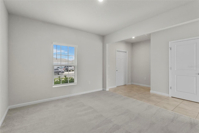 1506 Finnigan Cir, Haines City, FL 33844 - empty room featuring light tile patterned floors, baseboards, and light carpet
