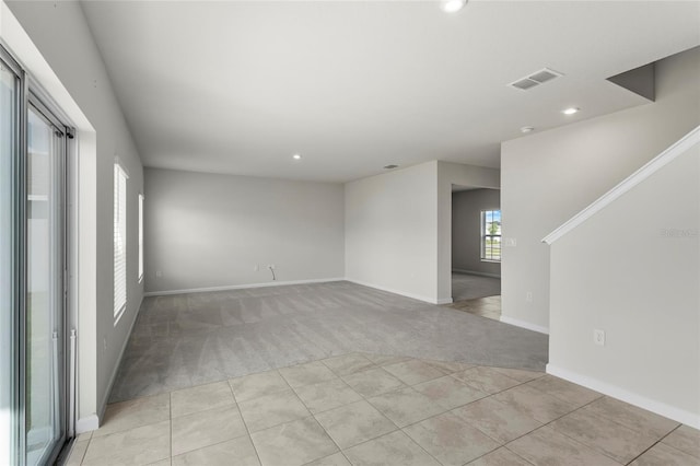 1506 Finnigan Cir, Haines City, FL 33844 - unfurnished room with light tile patterned floors, visible vents, baseboards, recessed lighting, and light colored carpet