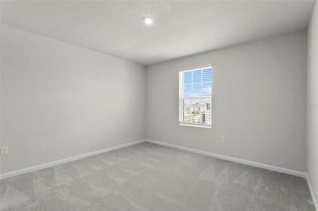 1506 Finnigan Cir, Haines City, FL 33844 - unfurnished room featuring baseboards and light carpet
