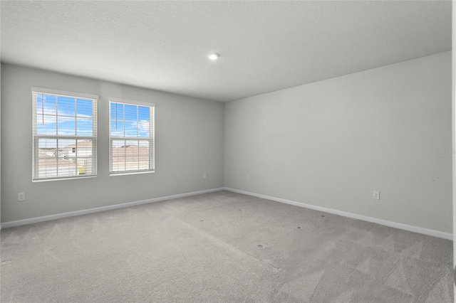 1506 Finnigan Cir, Haines City, FL 33844 - empty room featuring baseboards, carpet, and a textured ceiling