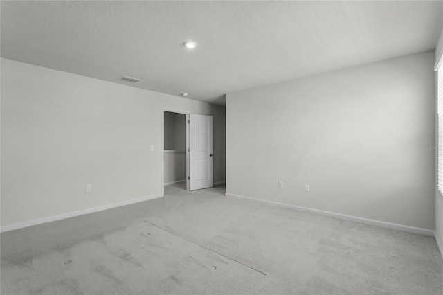 1506 Finnigan Cir, Haines City, FL 33844 - spare room featuring visible vents, baseboards, light colored carpet, and a textured ceiling