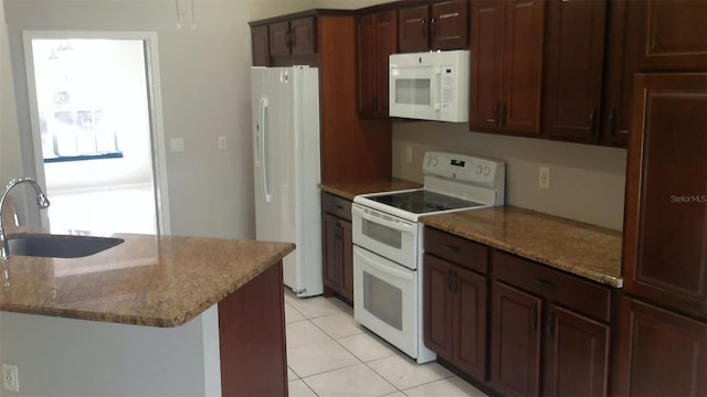 1760 Imperial Palm Dr, Apopka, FL 32712 - kitchen featuring light tile patterned floors, a sink, light stone counters, and white appliances