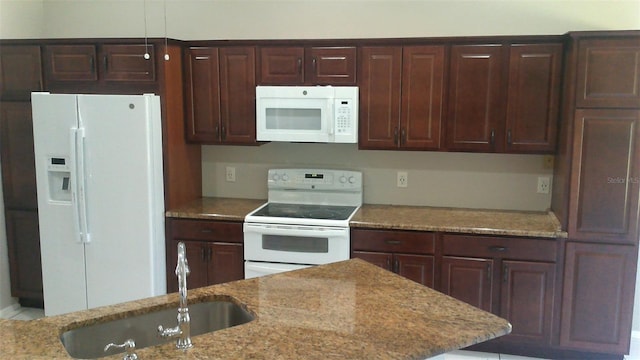 1760 Imperial Palm Dr, Apopka, FL 32712 - kitchen featuring dark brown cabinetry, light stone countertops, a sink, and white appliances