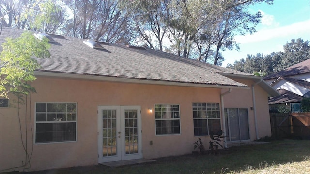 1760 Imperial Palm Dr, Apopka, FL 32712 - back of property with stucco siding, a shingled roof, fence, and french doors