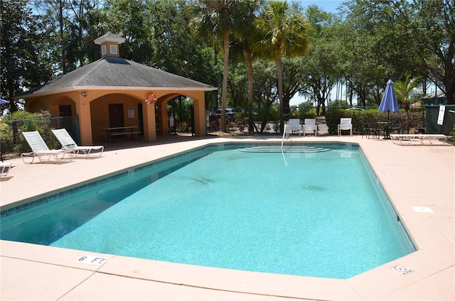 community pool featuring a patio area and fence