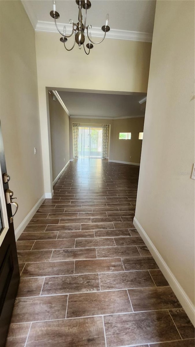 2749 Sand Oak Loop, Apopka, FL 32712 - hallway featuring ornamental molding, wood tiled floors, and a chandelier