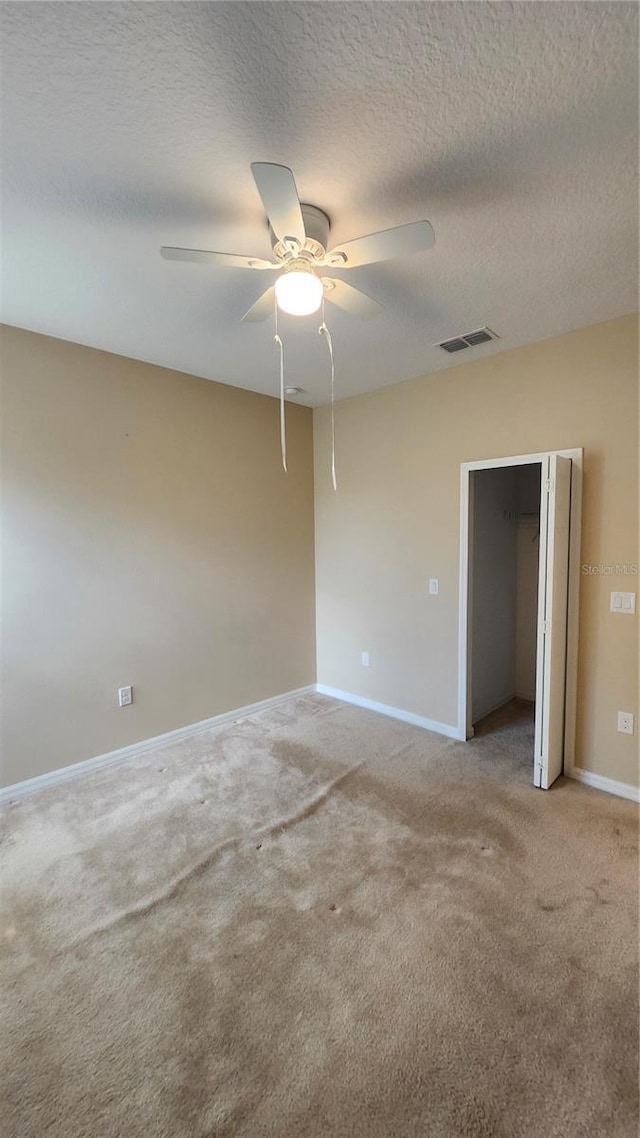 2749 Sand Oak Loop, Apopka, FL 32712 - unfurnished room with light colored carpet, a ceiling fan, and a textured ceiling