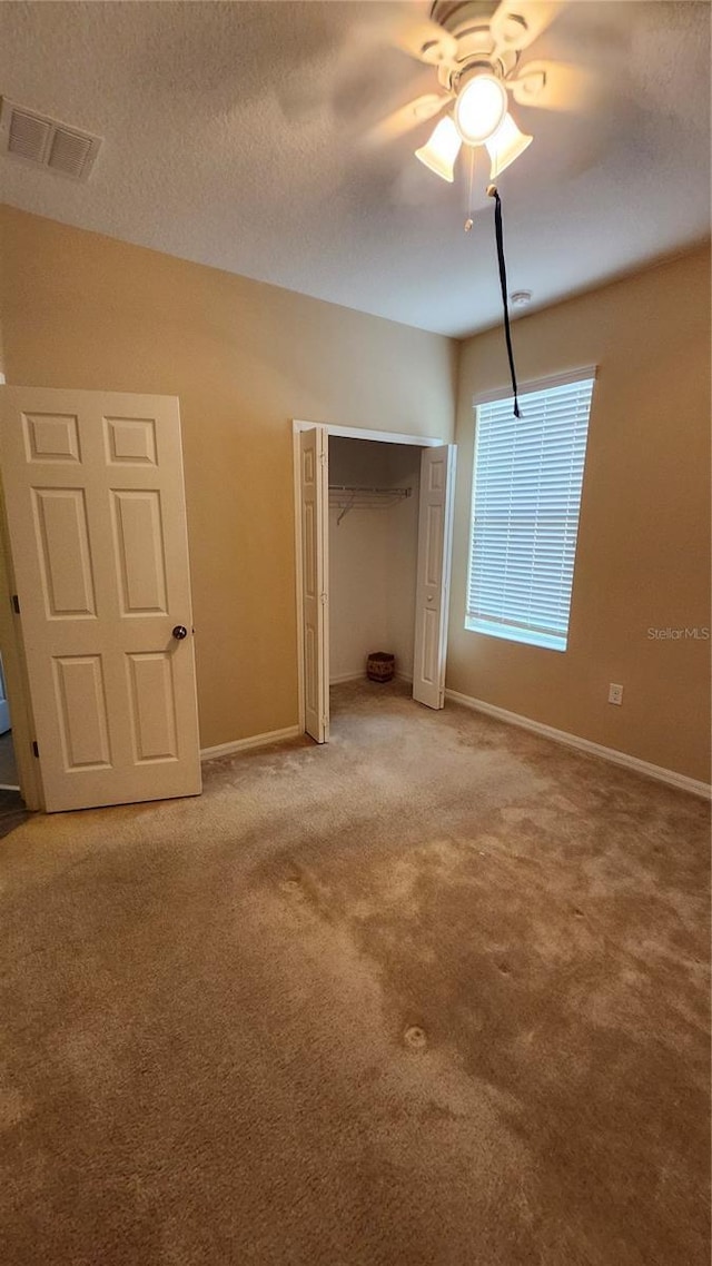 2749 Sand Oak Loop, Apopka, FL 32712 - unfurnished bedroom featuring light colored carpet, a closet, and a ceiling fan