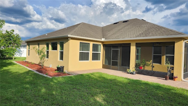 2749 Sand Oak Loop, Apopka, FL 32712 - rear view of house with a sunroom, a shingled roof, a lawn, and stucco siding
